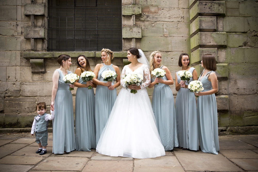 wedding photographer image of bride laughing with bridesmaids