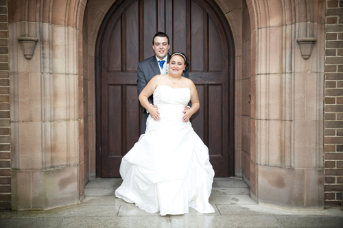 wedding photographer image of bride and groom standing by church doors