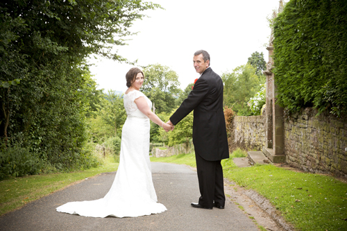 wedding photographer image of bride and groom by How Caple Court