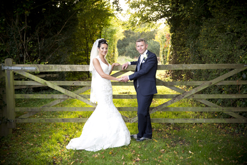 wedding photographer image of bride and groom by country gate